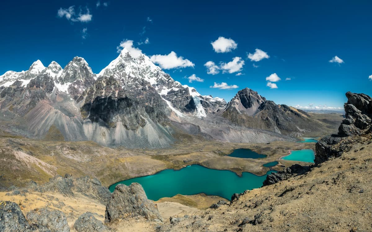 Ausangate Trek Rainbow Mountain - Turquoise alpine lake below the snowcapped summits